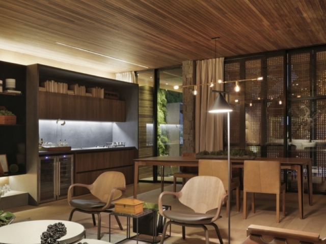 Casa Lite SP / Duda Porto Arquitectura - La mesa de comedor para 10 comensales se fusiona con la cocina abierta.